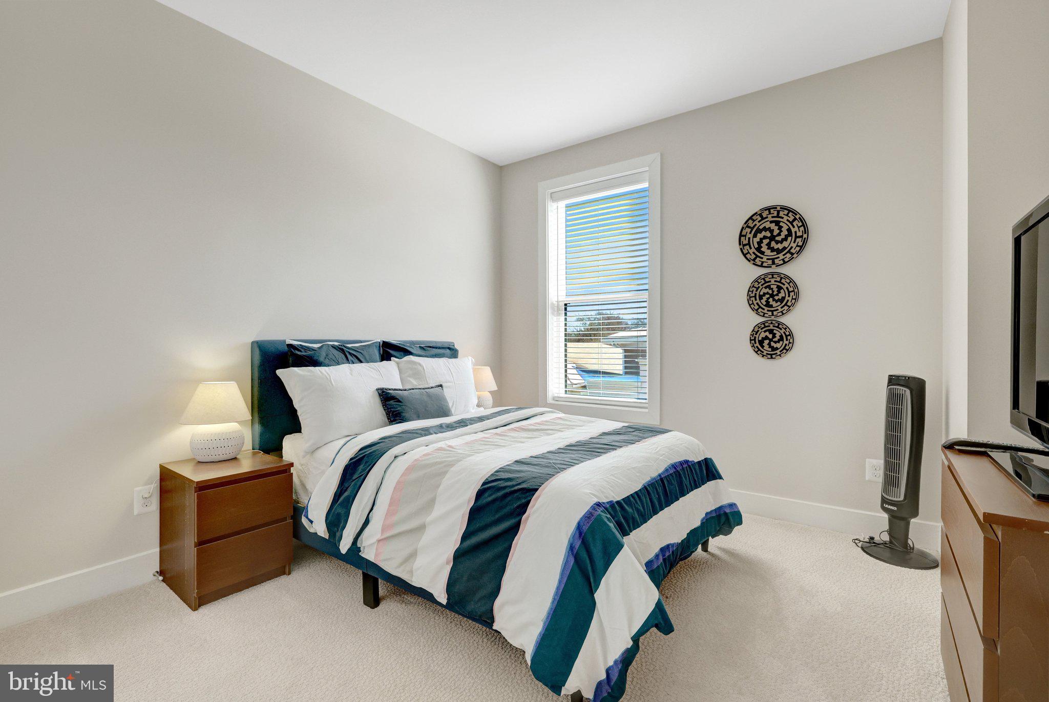 1694 Bandit Loop, Unit 17B Reston, VA 20190 - Photo 29 of 46 a bed sitting in a bedroom next to a window