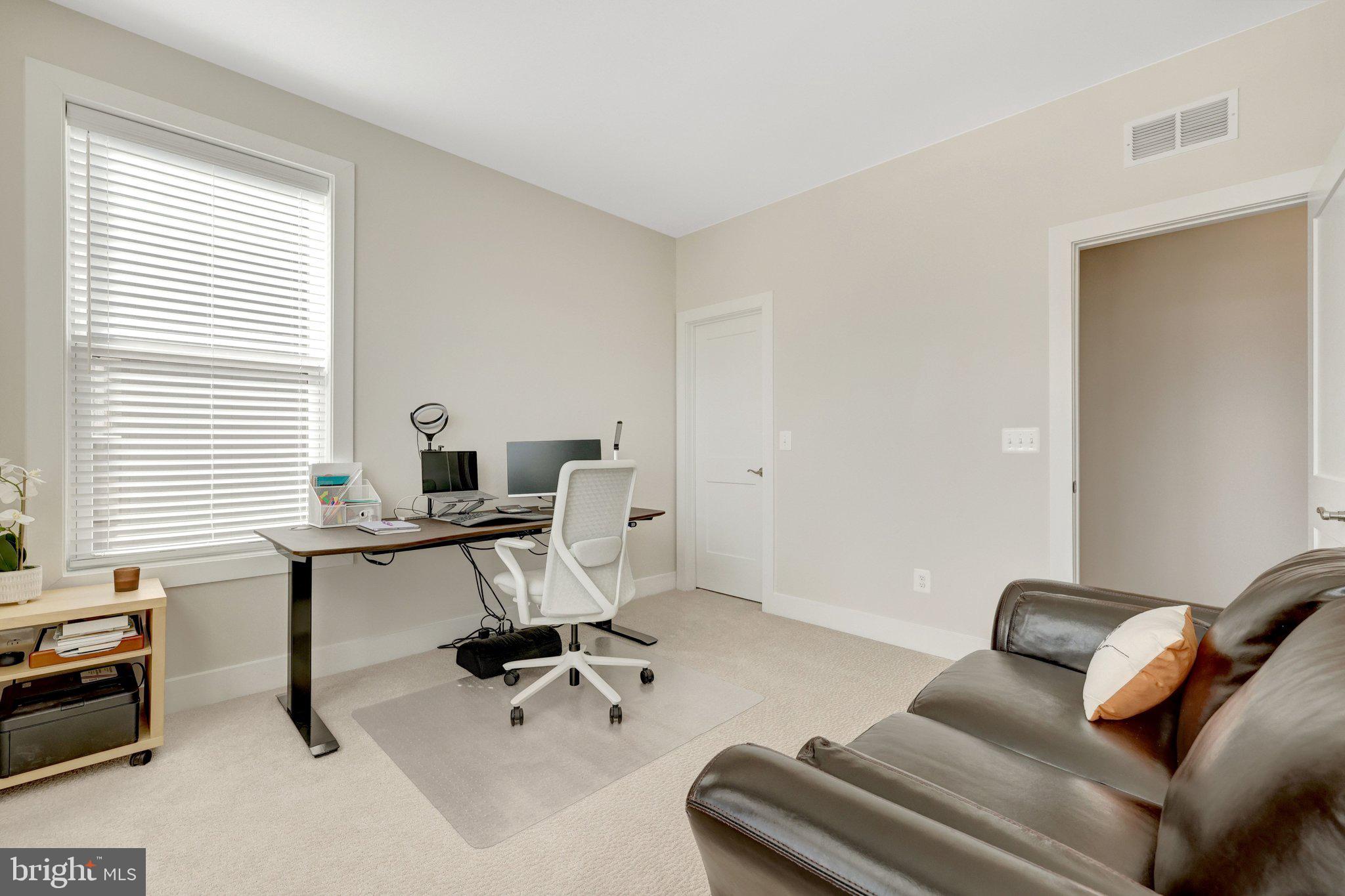 1694 Bandit Loop, Unit 17B Reston, VA 20190 - Photo 32 of 46 a view of a workspace with a window and couch