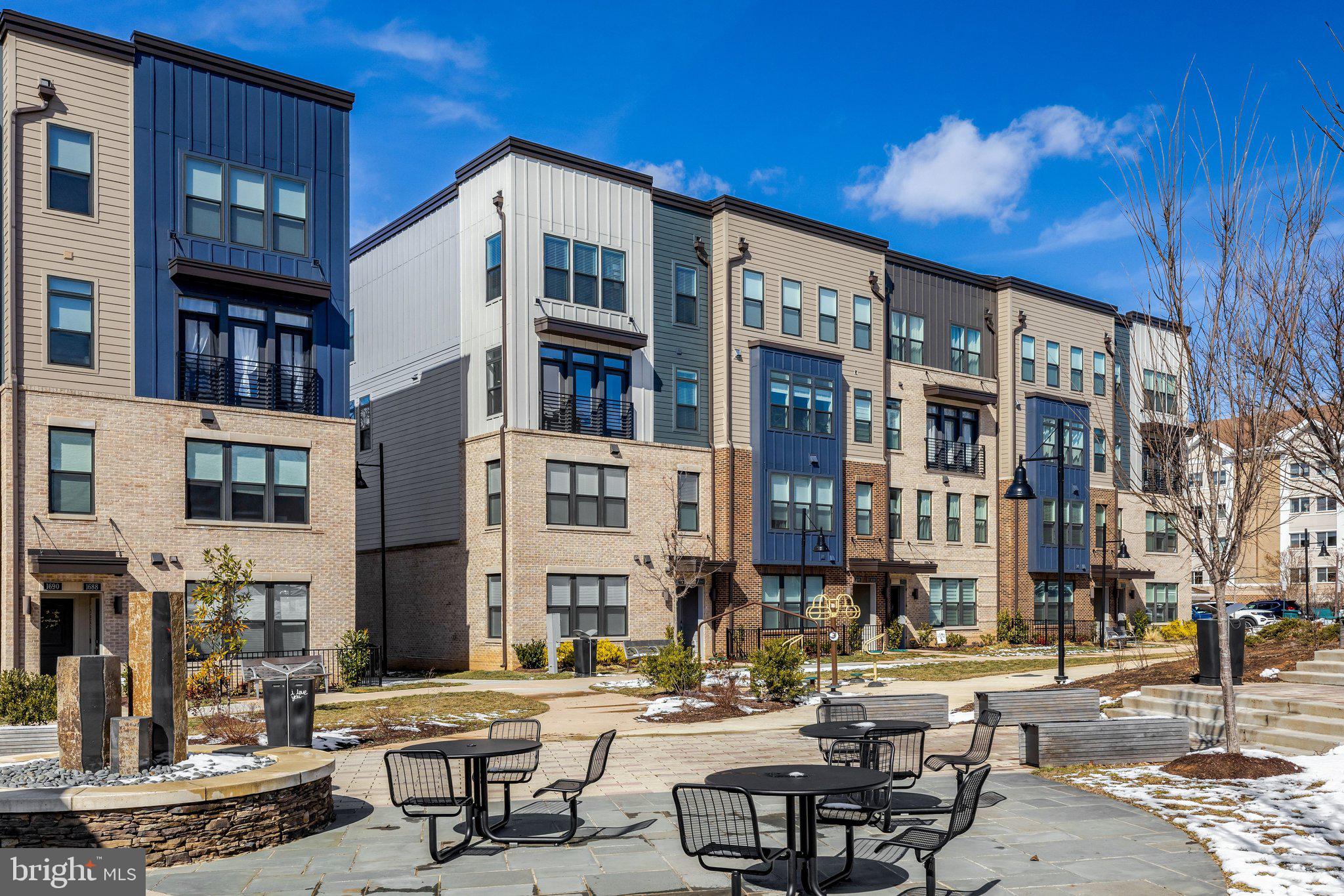1694 Bandit Loop, Unit 17B Reston, VA 20190 - Photo 40 of 46 a city street lined with tall buildings and a fountain