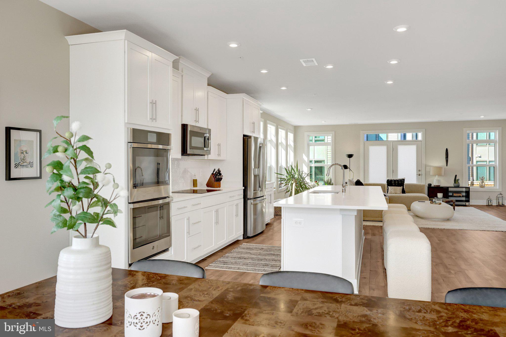 1694 Bandit Loop, Unit 17B Reston, VA 20190 - Photo 4 of 46 a large white kitchen with cabinets stove and refrigerator