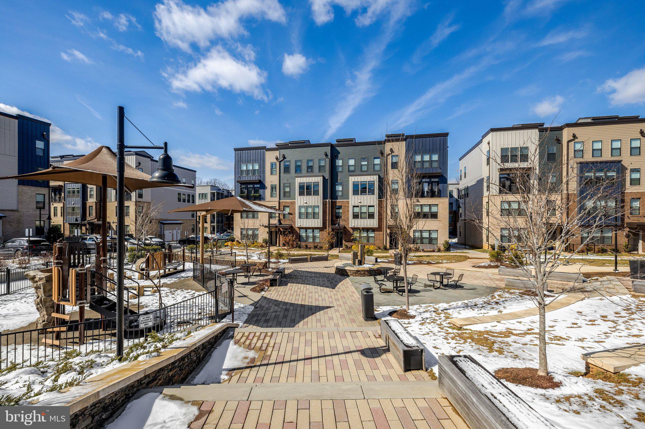 1694 Bandit Loop, Unit 17B Reston, VA 20190 - Photo 41 of 46 a view of a patio with chairs and umbrellas on a table