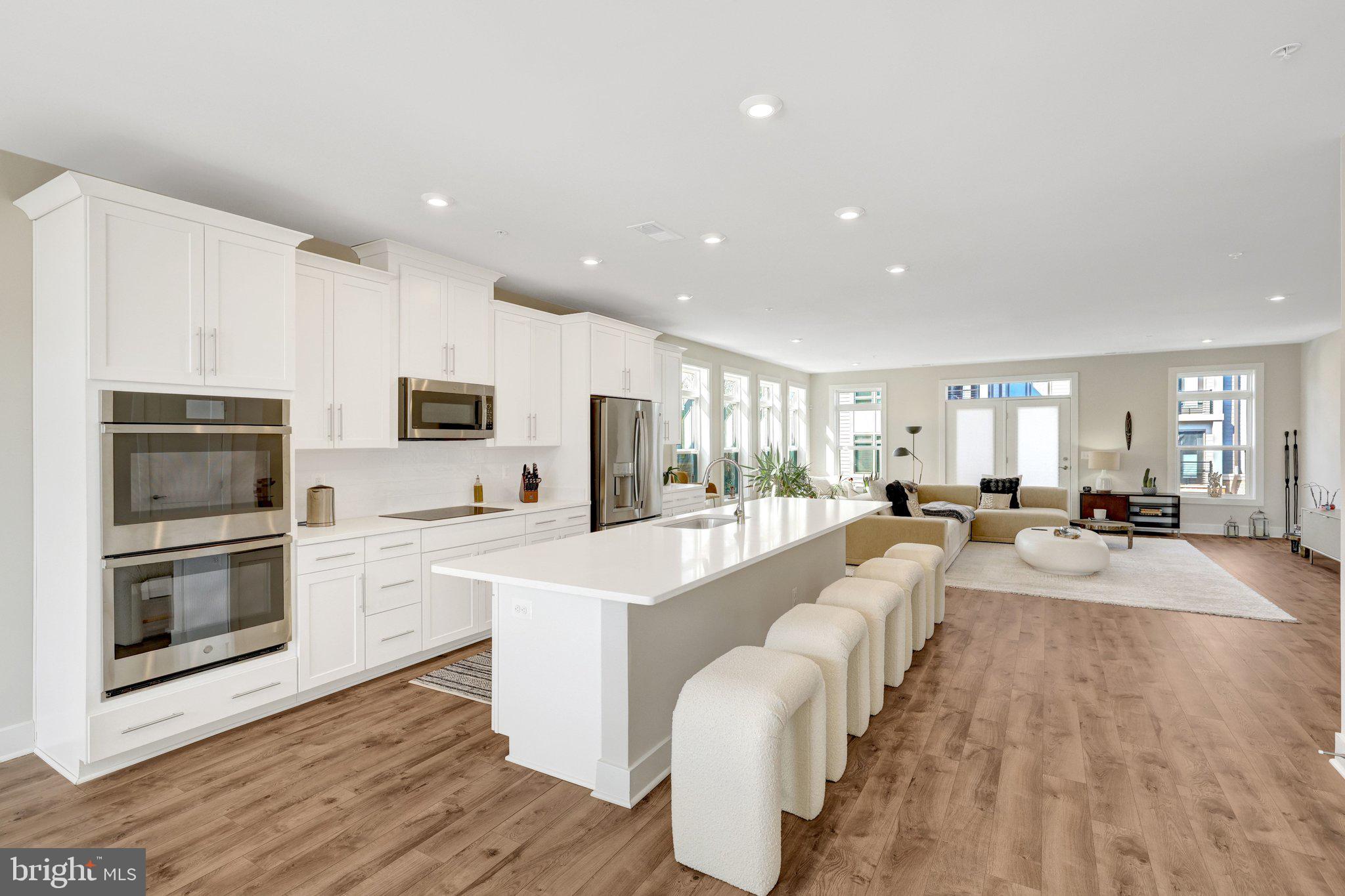 1694 Bandit Loop, Unit 17B Reston, VA 20190 - Photo 5 of 46 a large white kitchen with stainless steel appliances