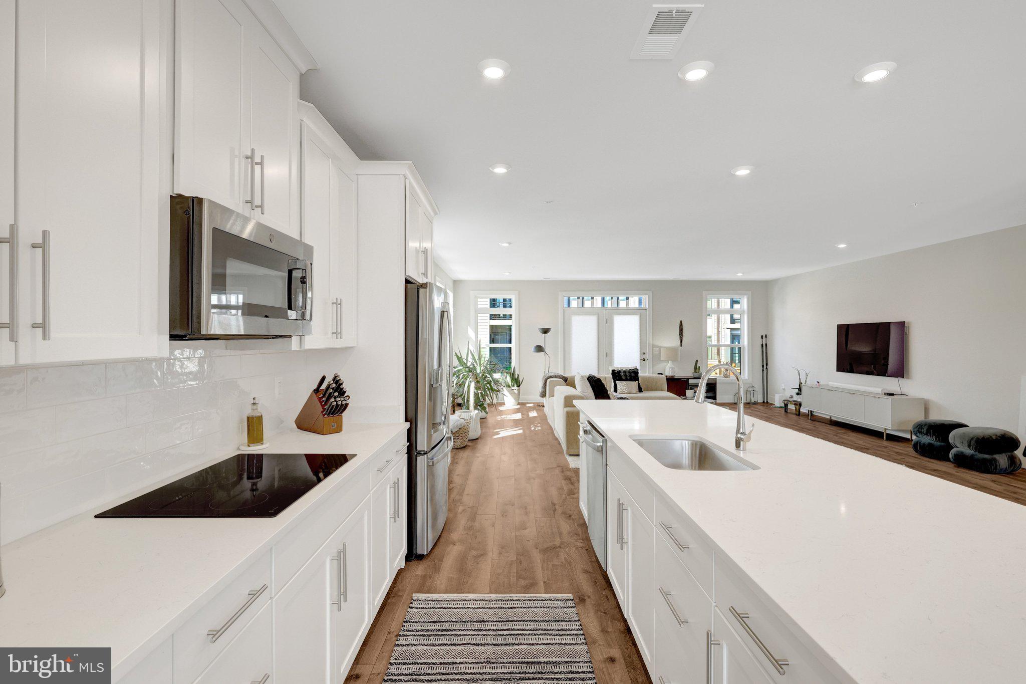 1694 Bandit Loop, Unit 17B Reston, VA 20190 - Photo 6 of 46 a large white kitchen with a lot of counter space and a sink