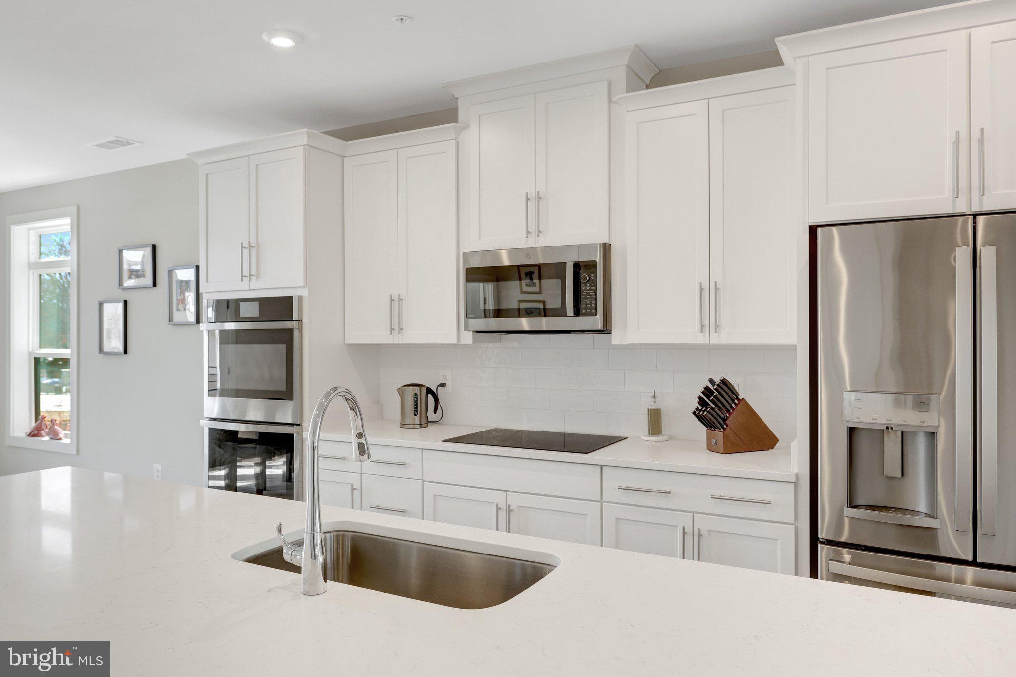1694 Bandit Loop, Unit 17B Reston, VA 20190 - Photo 8 of 46 a kitchen with stainless steel appliances granite countertop a refrigerator sink and stove