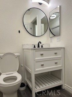 15177 Braxton Street Adelanto, CA 92301 - Photo 18 of 34 a bathroom with a toilet a sink and mirror