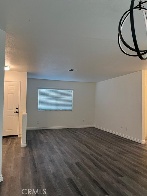 15177 Braxton Street Adelanto, CA 92301 - Photo 2 of 34 wooden floor in a hall with an empty room