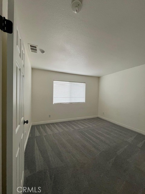 15177 Braxton Street Adelanto, CA 92301 - Photo 24 of 34 a view of an empty room and a window