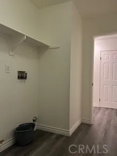 an empty room with wooden floor and closet