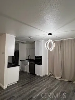 a kitchen with granite countertop a stove and a refrigerator