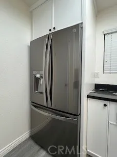a metallic refrigerator freezer sitting in a kitchen