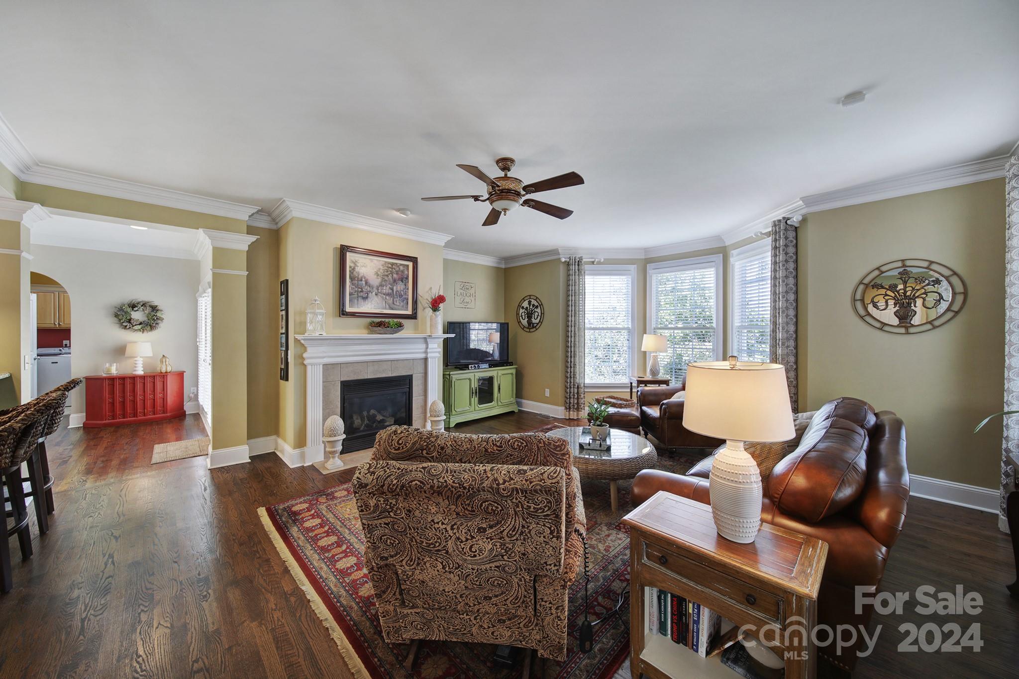 724 Shady Grove Crossing Fort Mill, SC 29708 - Photo 12 of 48 a living room with furniture a fireplace and a large window