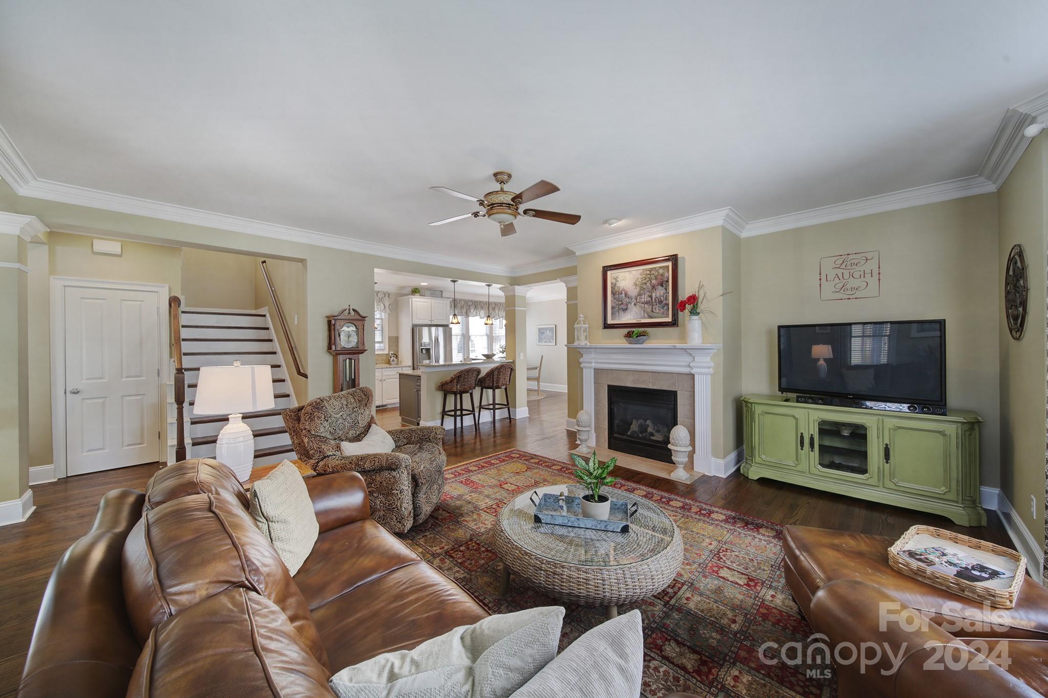 724 Shady Grove Crossing Fort Mill, SC 29708 - Photo 13 of 48 a living room with furniture a fireplace and a flat screen tv