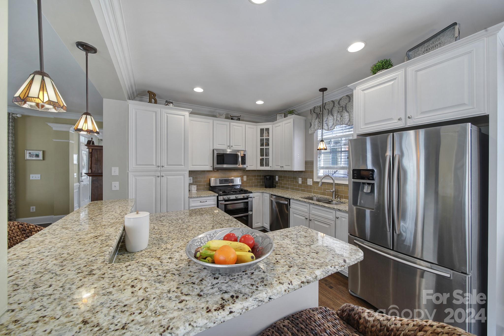 724 Shady Grove Crossing Fort Mill, SC 29708 - Photo 17 of 48 a kitchen with stainless steel appliances granite countertop a refrigerator sink and cabinets