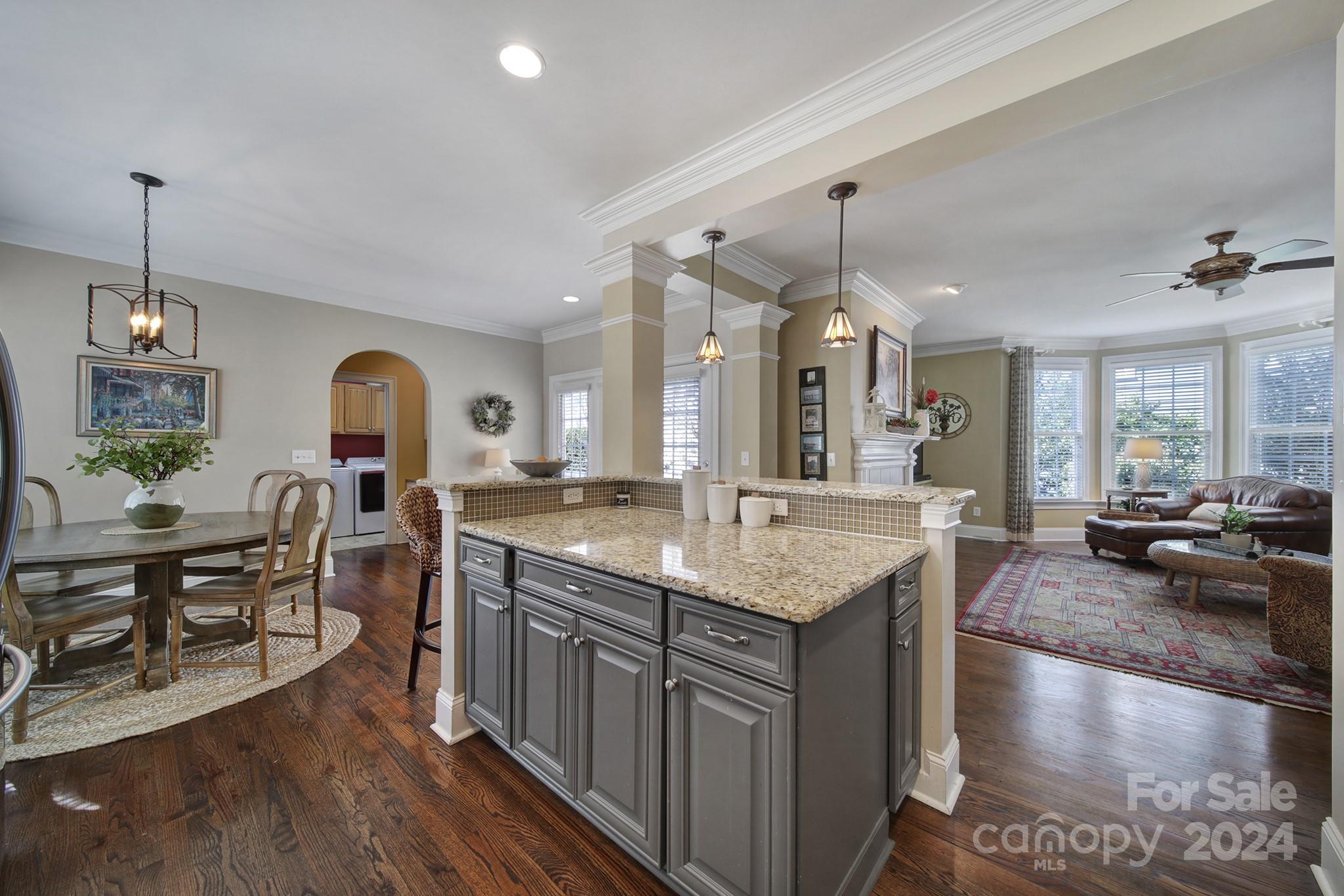 724 Shady Grove Crossing Fort Mill, SC 29708 - Photo 18 of 48 a kitchen with center island dining table and chairs