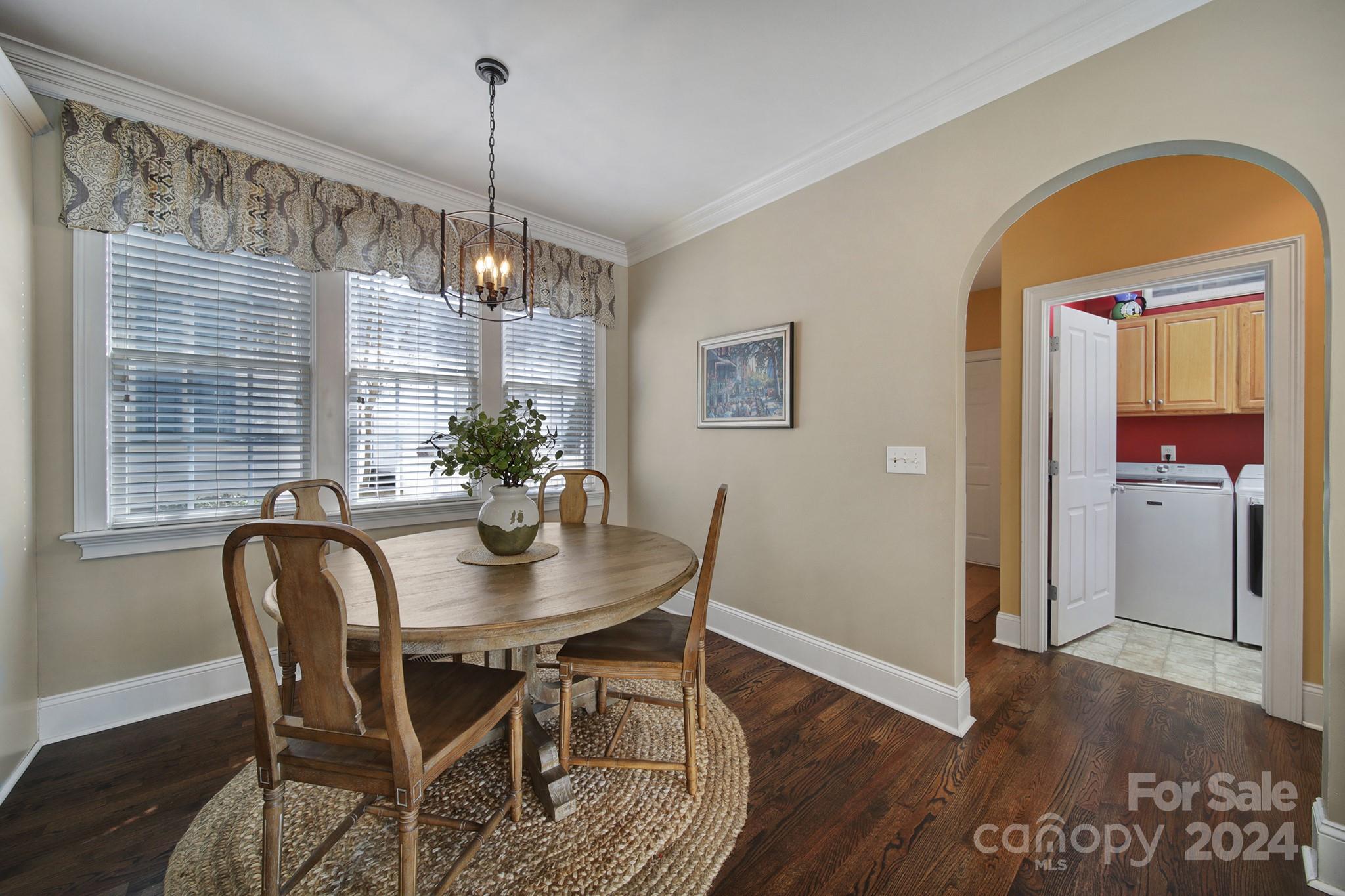 724 Shady Grove Crossing Fort Mill, SC 29708 - Photo 20 of 48 a dining room with furniture a chandelier and wooden floor
