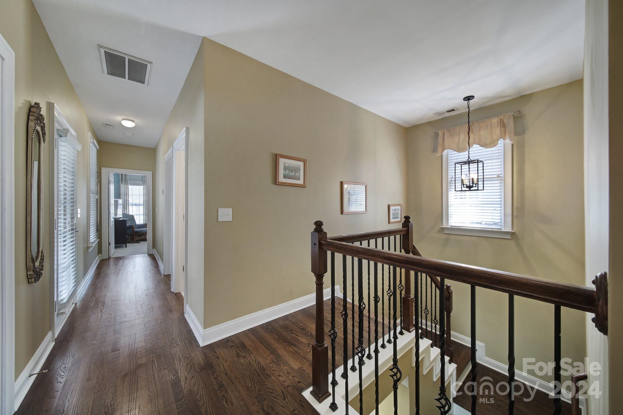 724 Shady Grove Crossing Fort Mill, SC 29708 - Photo 25 of 48 a view of a hallway with wooden floor and windows