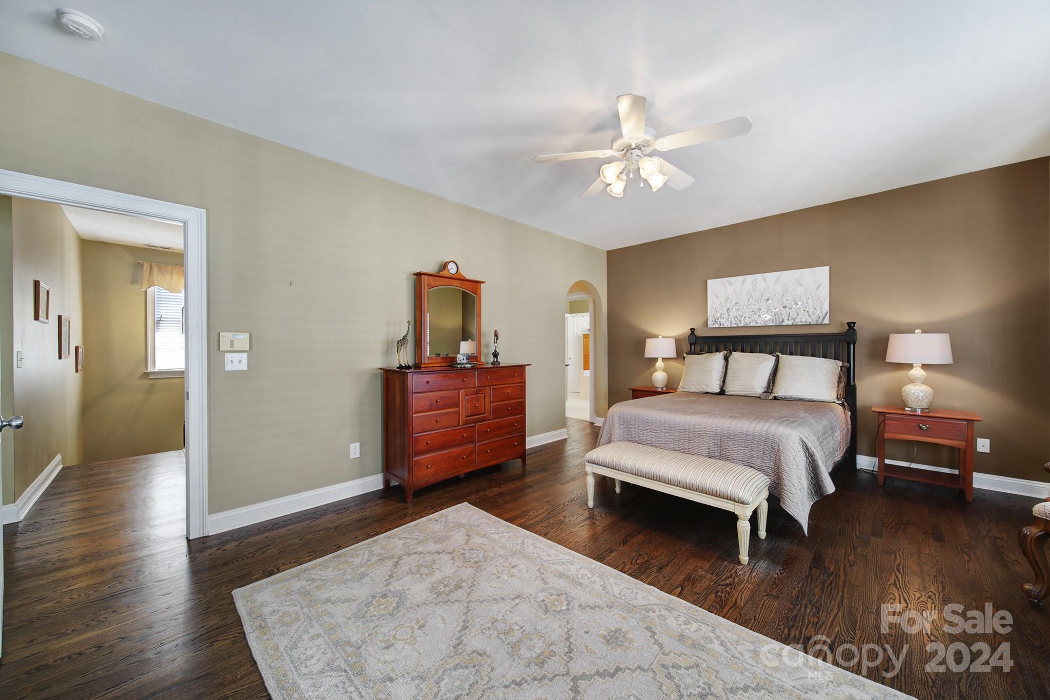 724 Shady Grove Crossing Fort Mill, SC 29708 - Photo 27 of 48 a bedroom with a bed and wooden floor