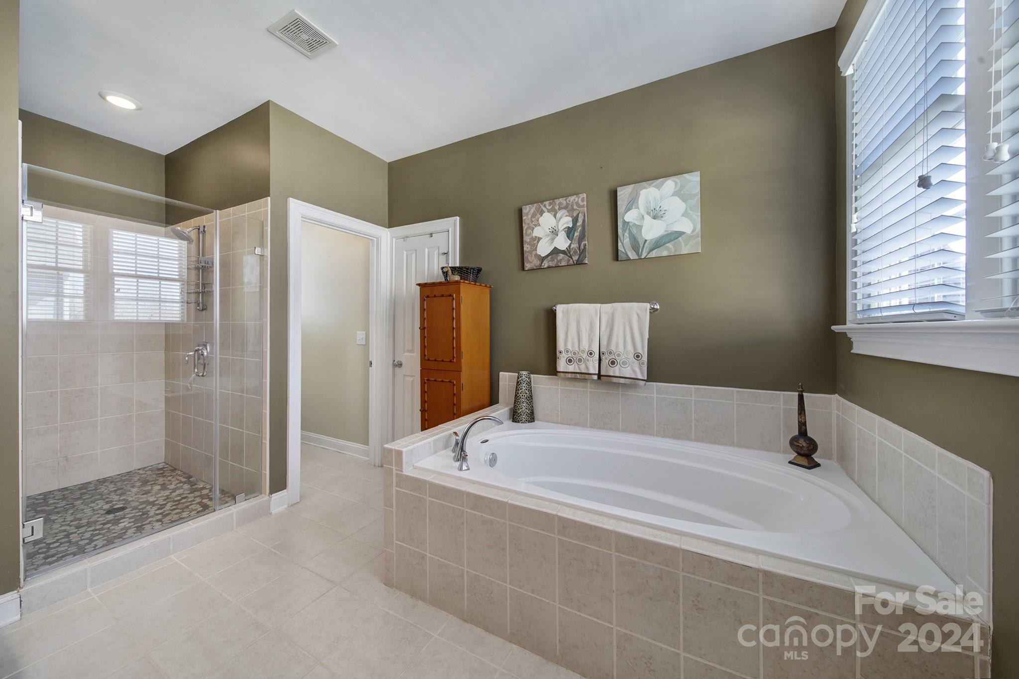 724 Shady Grove Crossing Fort Mill, SC 29708 - Photo 29 of 48 a bathroom with a bathtub and a shower