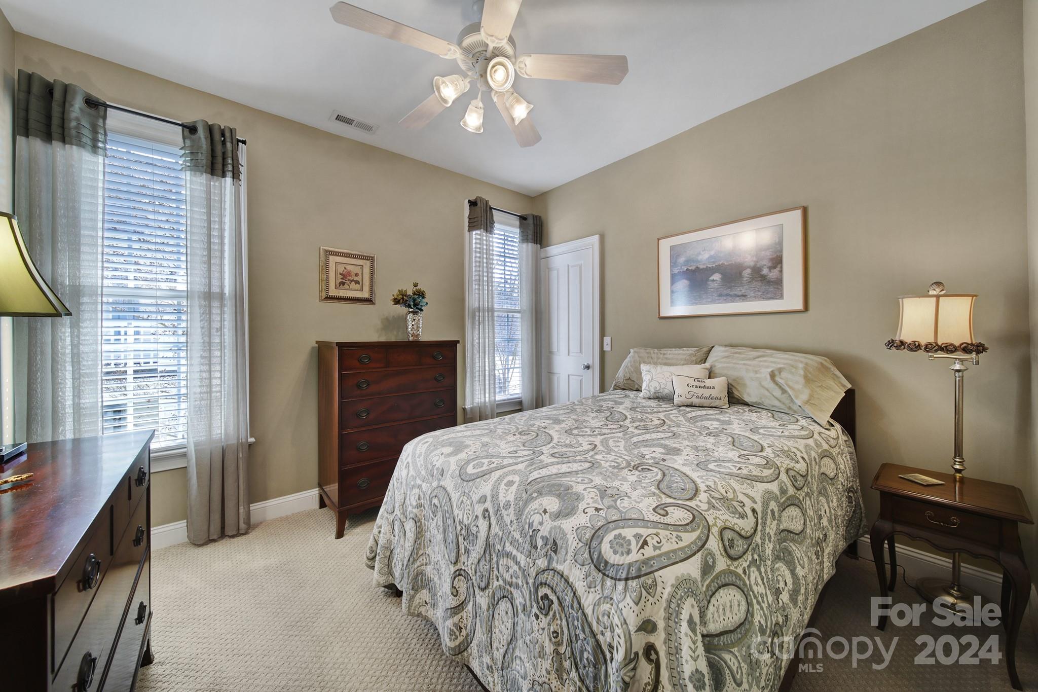 724 Shady Grove Crossing Fort Mill, SC 29708 - Photo 30 of 48 a bedroom with a bed and a chandelier