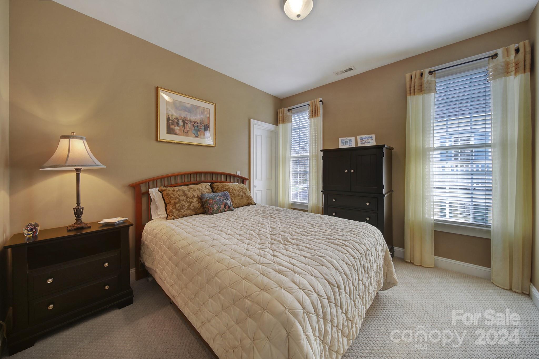 724 Shady Grove Crossing Fort Mill, SC 29708 - Photo 33 of 48 a bedroom with a bed and a lamp