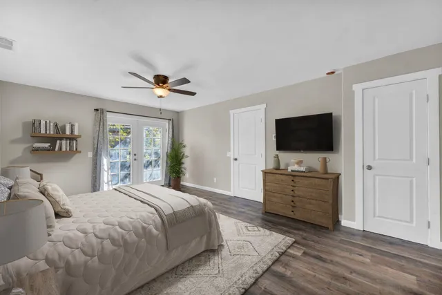 a bedroom with a bed and a flat screen tv