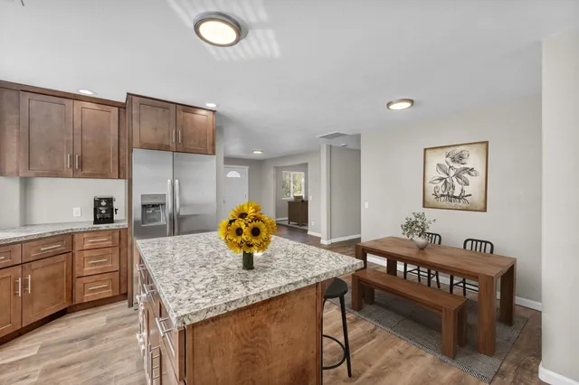 a kitchen that has a table and chairs in it