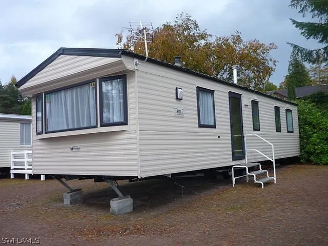 a view of a small house with backyard
