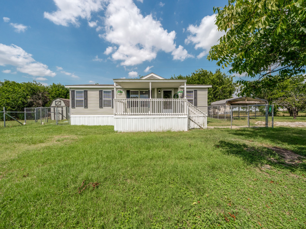 4654 Old Howard Road Temple, TX 76504 - Photo 2 of 25 A well-maintained home awaits, featuring a welcoming covered porch, sturdy chain-link fencing, and a convenient carport.