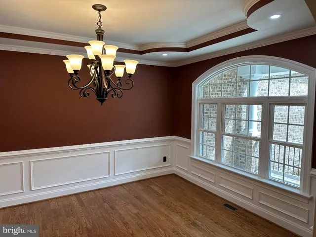 a view of a room with a large window and chandelier