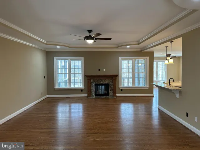 a view of a livingroom with fireplace wooden floor and a window