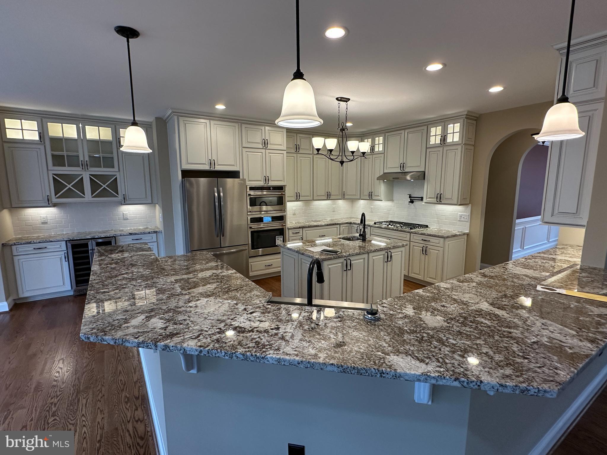 2225 Cedar Grove Road Winchester, VA 22603 - Photo 25 of 48 a kitchen with stainless steel appliances kitchen island granite countertop a sink stove and refrigerator