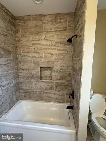 a bathroom with a shower and a toilet