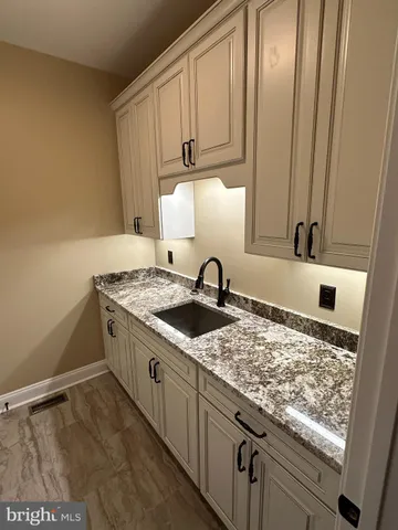 a kitchen with granite countertop a sink and a stove