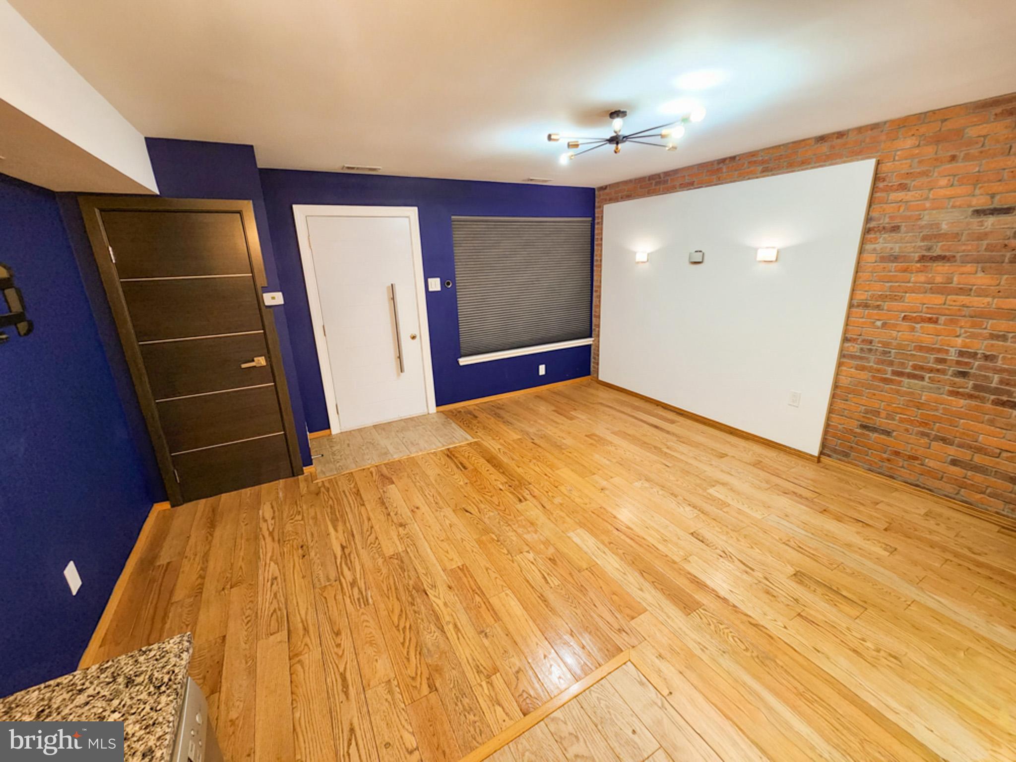 12135 Academy Road, Unit 77 Philadelphia, PA 19154 - Photo 2 of 12 a bedroom with a bed and wooden floor