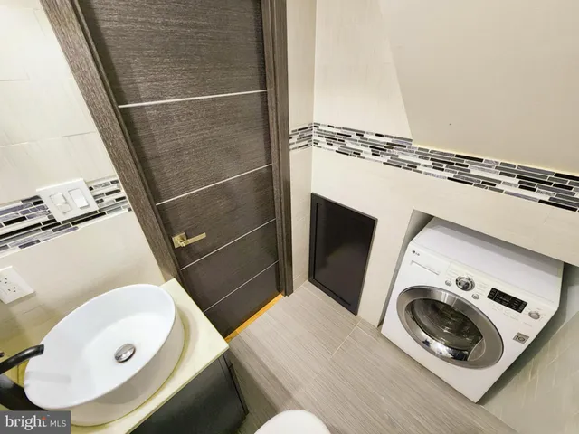 a bathroom with a toilet mirror and sink