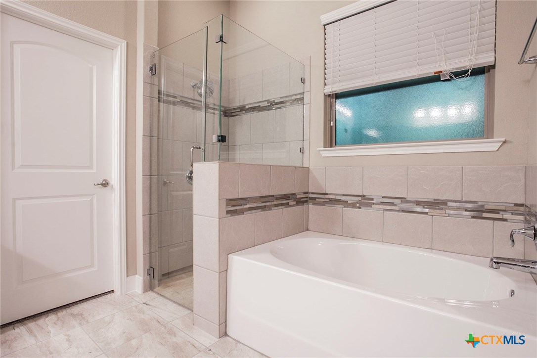 549 Wills Point Way Belton, TX 76513 - Photo 15 of 31 a bathroom with a tub a mirror and a shower