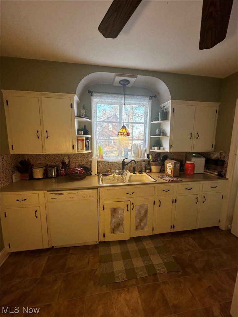 2444 Manchester Road Akron, OH 44314 - Photo 15 of 26 Kitchen with dishwasher, dark tile flooring, ceiling fan, sink, and decorative light fixtures
