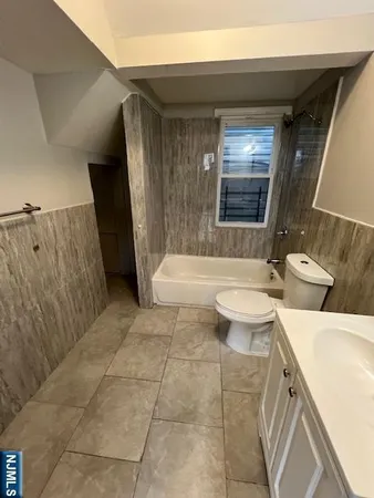a bathroom with a toilet a sink and bathtub