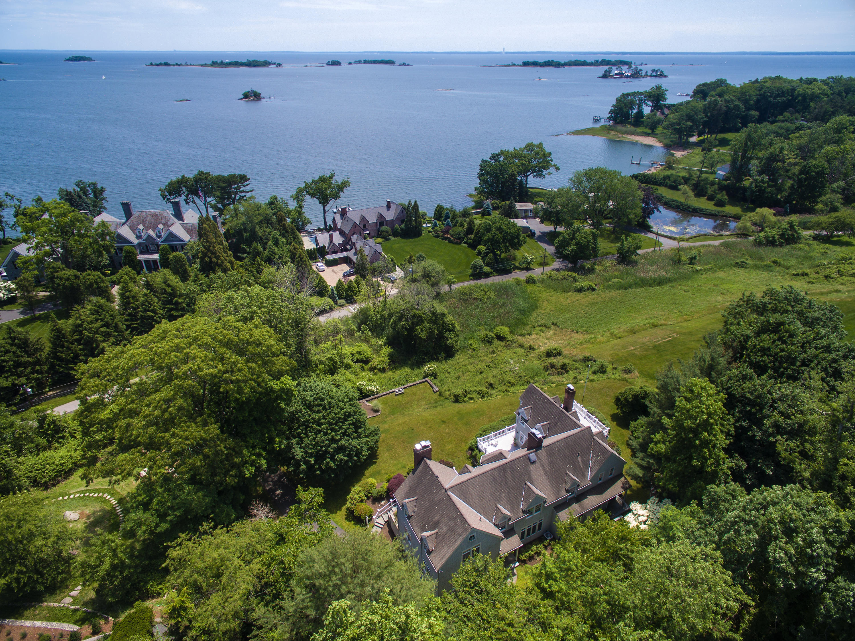 an aerial view of a house with garden space and street view