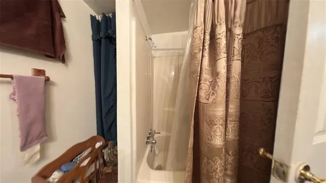 a bathroom with a shower and a mirror