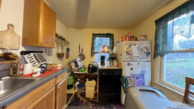 a view of a room with workspace and a window