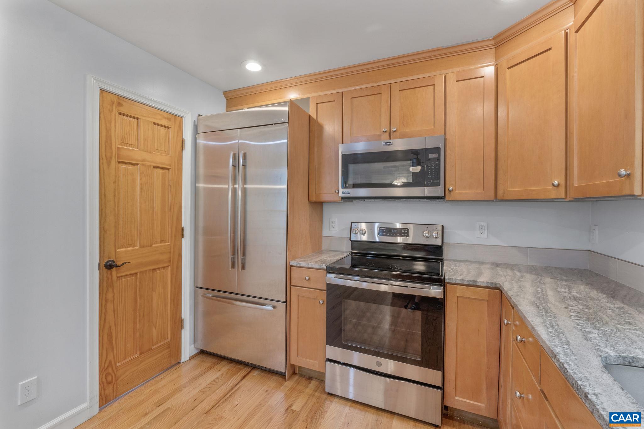 118 Roy's Place Charlottesville, VA 22902 - Photo 17 of 42 a kitchen with stainless steel appliances granite countertop a stove a refrigerator and a microwave