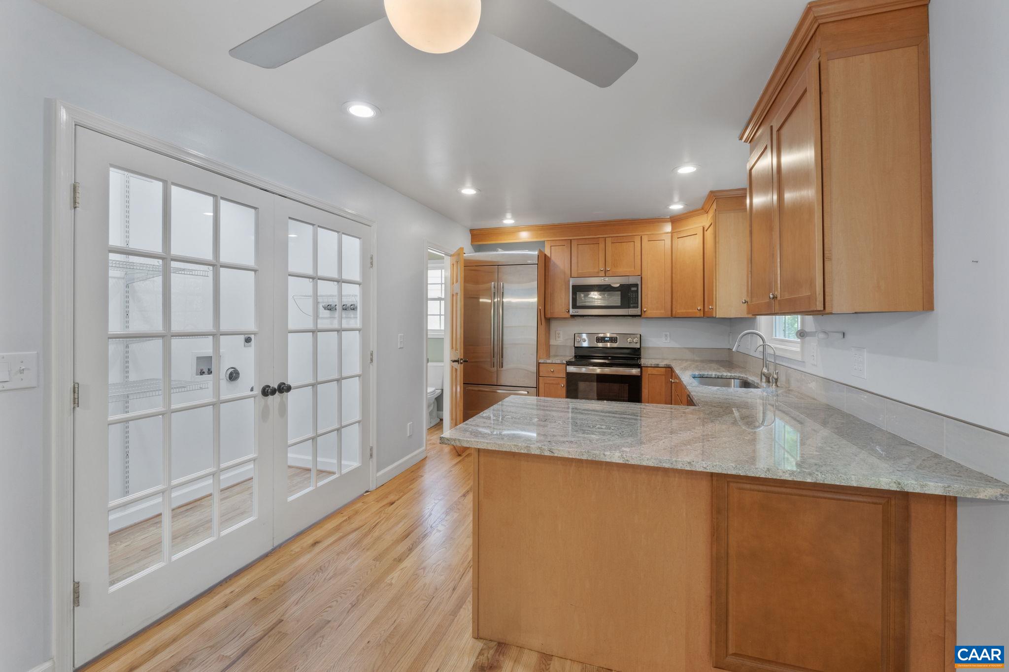 118 Roy's Place Charlottesville, VA 22902 - Photo 20 of 42 a kitchen with stainless steel appliances granite countertop a sink a stove and a refrigerator