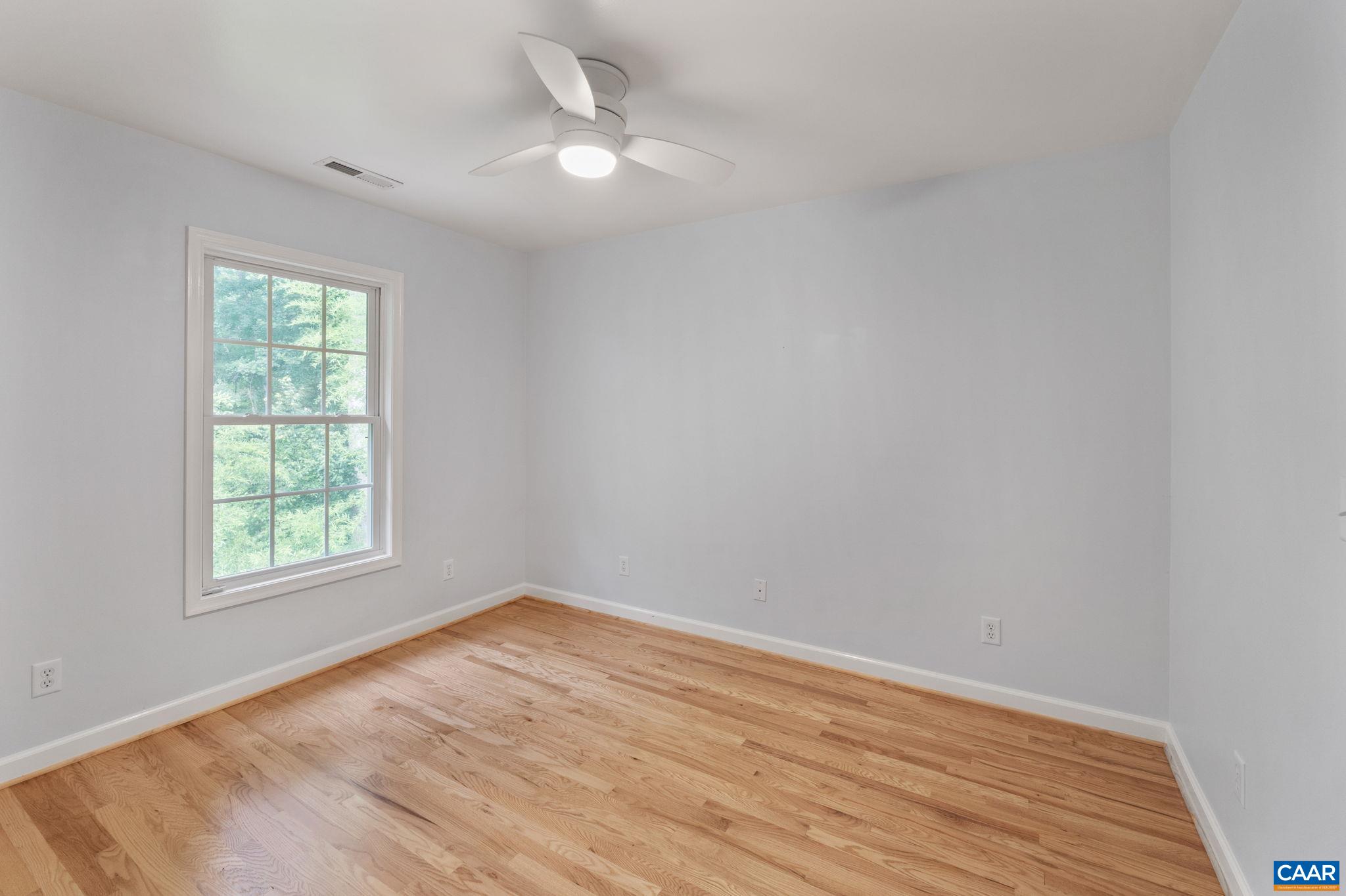 118 Roy's Place Charlottesville, VA 22902 - Photo 23 of 42 an empty room with wooden floor and windows