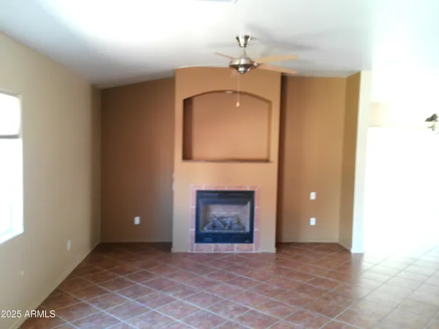 a view of an empty room with a fireplace