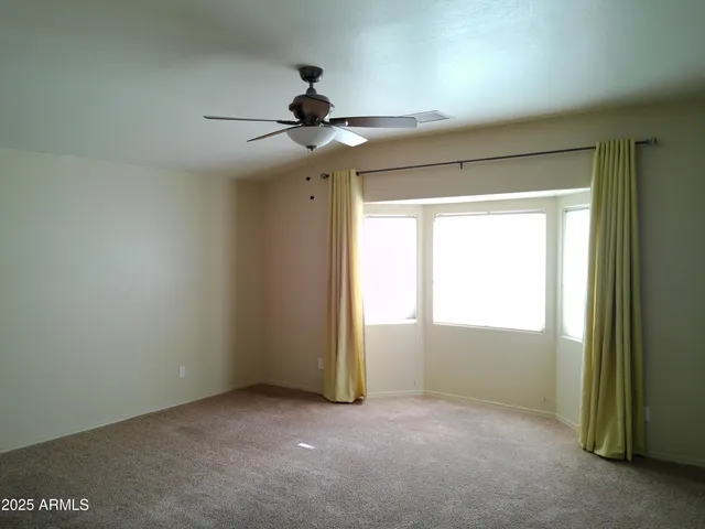 an empty room with a empty space and windows