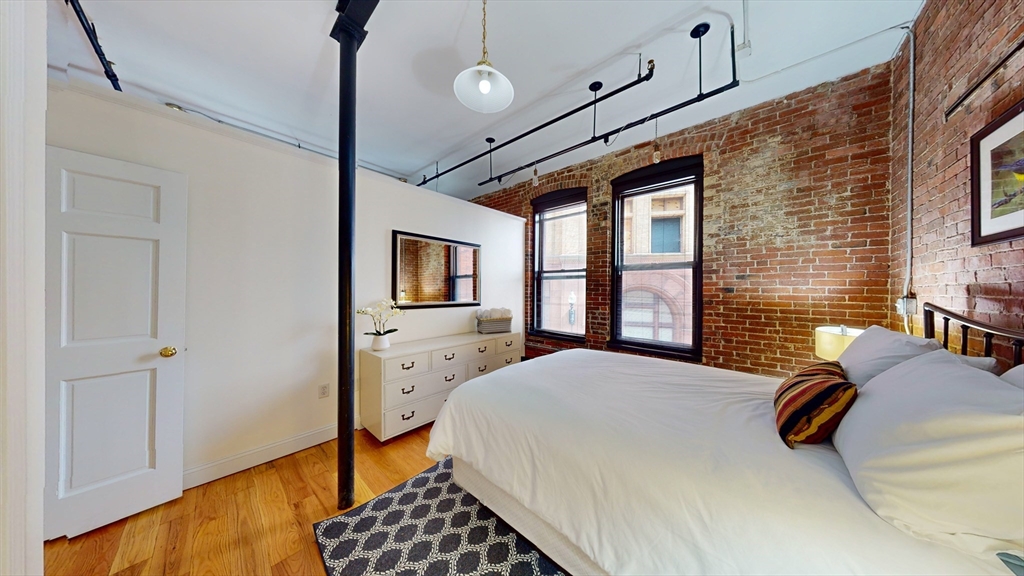 19 Stanhope Street, Unit 2B Boston, MA 02116 - Photo 11 of 15 a bedroom with a bed dresser and a window