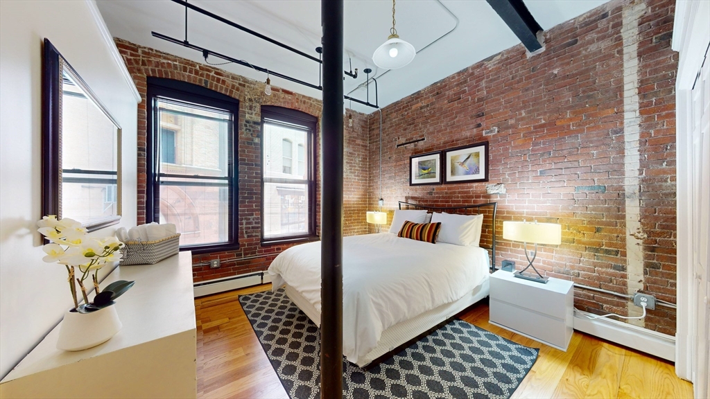 19 Stanhope Street, Unit 2B Boston, MA 02116 - Photo 9 of 15 a bedroom with a bed and wooden floor