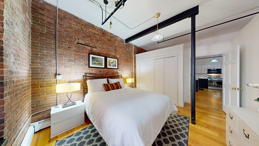 19 Stanhope Street, Unit 2B Boston, MA 02116 - Photo 10 of 15 a bedroom with a bed and wooden floor