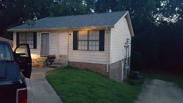 a view of a house with backyard sitting area and garden